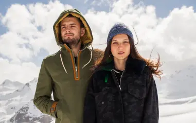 Man and woman in winter jackets in snowy setting for Jackets Manufacturer.