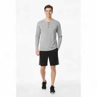 Man wearing a plain dark gray long-sleeve crew neck T-shirt with blue jeans